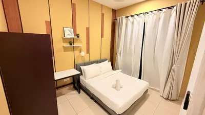 a small room with a bed and a desk at Trion KL Family Residences in Kuala Lumpur