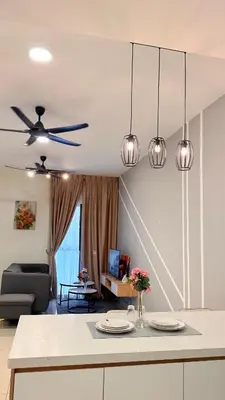 a kitchen with a ceiling fan and a living room at Trion KL Family Residences in Kuala Lumpur