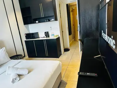 a hotel room with a bed and a kitchen in it at Crystal At Axon Residence KL in Kuala Lumpur