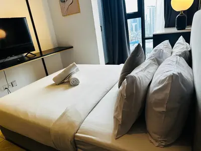 a bedroom with a bed with a remote control on it at Crystal At Axon Residence KL in Kuala Lumpur