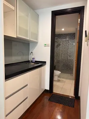 a kitchen with a sink and a bathroom with a toilet at Bukit Bintang By Eryan Guest House in Kuala Lumpur
