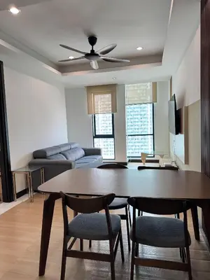 a living room with a table and chairs and a couch at Bukit Bintang By Eryan Guest House in Kuala Lumpur