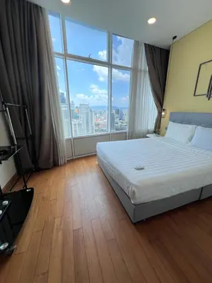 a hotel room with a bed and a large window at SKY suits private room apartments in Kuala Lumpur