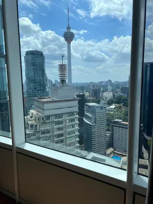 a view of a city skyline from a window at SKY suits private room apartments in Kuala Lumpur