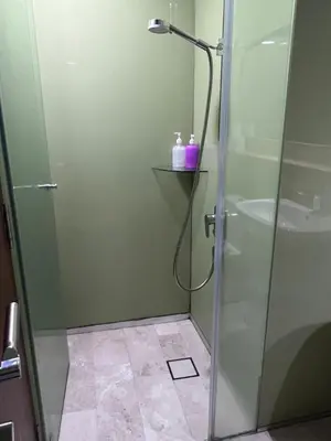 a shower with a glass door in a bathroom at SKY suits private room apartments in Kuala Lumpur