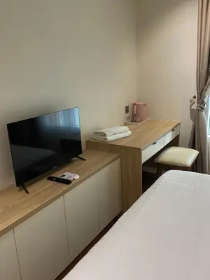a bedroom with a bed and a television on a desk at SKY suits private room apartments in Kuala Lumpur