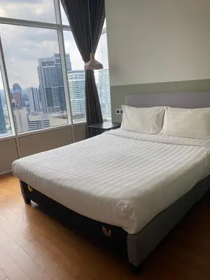 a large bed in a room with a large window at SKY suits private room apartments in Kuala Lumpur