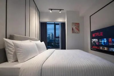 a bedroom with a bed with a view of the city at Axon Bukit Bintang By Sleeping Bird in Kuala Lumpur