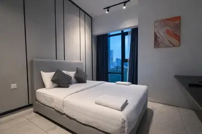 a bedroom with a large white bed with a window at Axon Bukit Bintang By Sleeping Bird in Kuala Lumpur