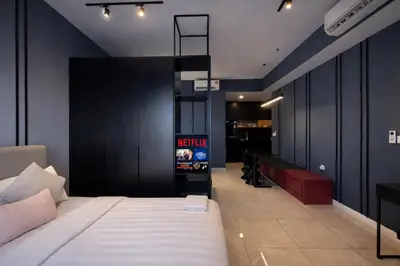 a bedroom with a bed and a black wall at Axon Bukit Bintang By Sleeping Bird in Kuala Lumpur