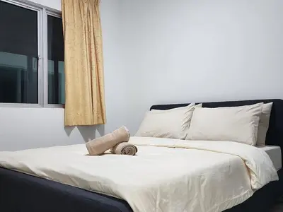 a bed with a towel on it with a window at Cozy Razak City 2B2B KLCC View Near KL Centre in Kuala Lumpur