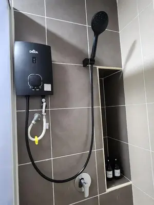 a shower in a bathroom with a blow dryer at Cozy Razak City 2B2B KLCC View Near KL Centre in Kuala Lumpur
