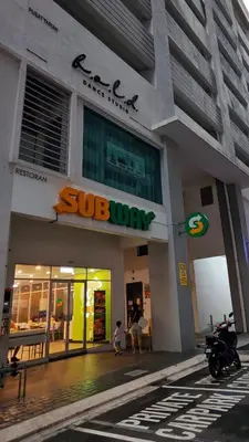 a building with a sub way sign in front of it at Cozy Razak City 2B2B KLCC View Near KL Centre in Kuala Lumpur