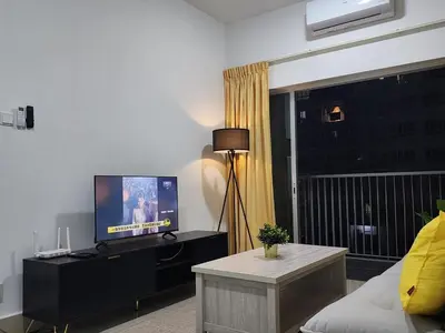 a living room with a tv and a couch at Cozy Razak City 2B2B KLCC View Near KL Centre in Kuala Lumpur