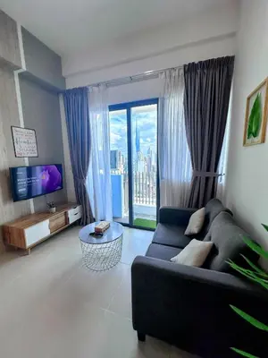 a living room with a couch and a large window at The Luxe KLCC By Serviced Apartment in Kuala Lumpur