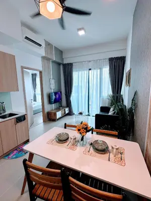 a kitchen and living room with a table and chairs at The Luxe KLCC By Serviced Apartment in Kuala Lumpur