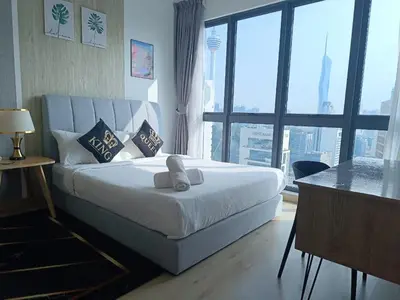 a bedroom with a large bed and a large window at The Luxe KLCC By Serviced Apartment in Kuala Lumpur