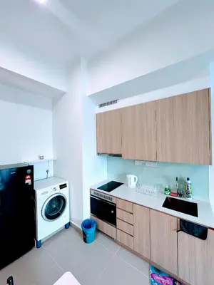 a kitchen with a washing machine and a dishwasher at The Luxe KLCC By Serviced Apartment in Kuala Lumpur