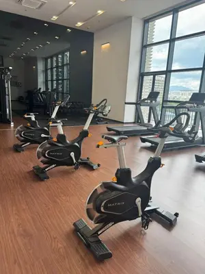 a row of exercise bikes in a gym at Chamber Residence klcc by Cozy Dream in Kuala Lumpur