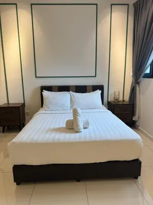 a bedroom with a bed with two towels on it at Chamber Residence klcc by Cozy Dream in Kuala Lumpur