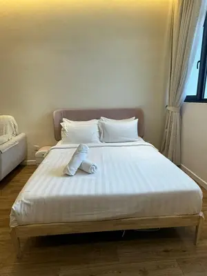 a teddy bear laying on a bed in a bedroom at Chamber Residence klcc by Cozy Dream in Kuala Lumpur