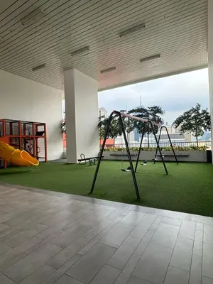 an empty room with a playground with a slide at Chamber Residence klcc by Cozy Dream in Kuala Lumpur
