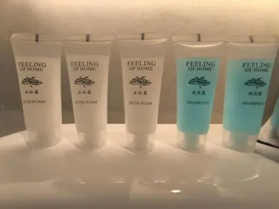 a group of four lotion bottles on a shelf at Tour & Travel Malaysia Axon Residence Bukit Bintang KL in Kuala Lumpur