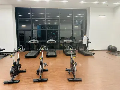 a man standing in a gym with several rows of exercise bikes at Cherry Homes at Chambers by Golden in Kuala Lumpur