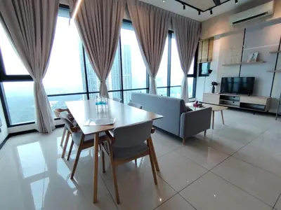 a living room with a table and a couch at First World Suite At Opus Residence KL 118 in Kuala Lumpur