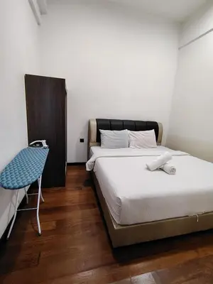 a bedroom with a bed and a chair at First World Suite At Opus Residence KL 118 in Kuala Lumpur