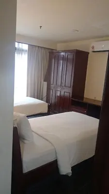 a hotel room with two beds and a window at BTS apartment at times square in Kuala Lumpur