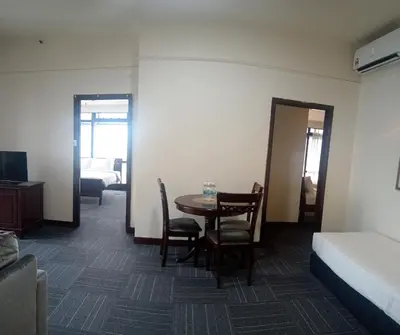 a room with a bed and a table and chairs at BTS apartment at times square in Kuala Lumpur