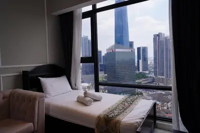 a hotel room with a bed and a large window at Axon Residence KLCC - CK Homestay in Kuala Lumpur