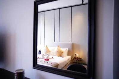 a mirror reflecting a bed in a room at Axon Residence KLCC - CK Homestay in Kuala Lumpur