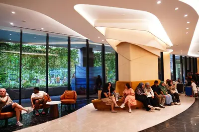 a group of people sitting in a lobby at Axon Residence KLCC - CK Homestay in Kuala Lumpur