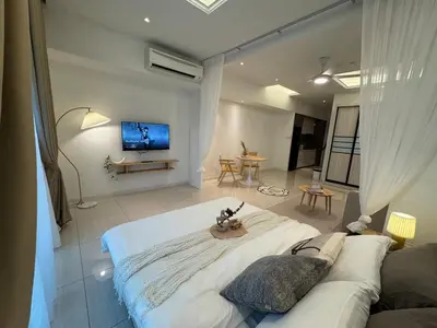 a living room with a couch and a tv at Dorsett Hartamas with Rooftop Pool and Bathtub in KL City #215 in Kuala Lumpur