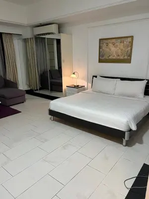 a bedroom with a bed and a living room at Apartment TS at Times Square in Kuala Lumpur