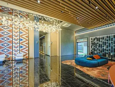 a room with a blue couch and a wall of wine bottles at KL Majestic VIP studio Massage Chair 26-1A KLCC view in Kuala Lumpur
