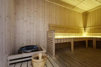 an empty wooden sauna with a tub and a toilet at KL Majestic VIP studio Massage Chair 26-1A KLCC view in Kuala Lumpur
