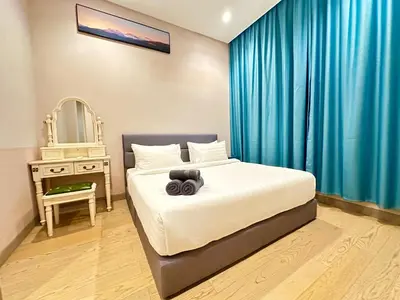a bedroom with a bed with a mirror and a table at Lucentia Premium stay Kuala Lumpur in Kuala Lumpur