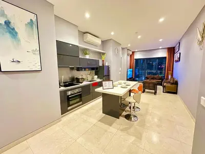 a kitchen and living room with a table and a couch at Lucentia Premium stay Kuala Lumpur in Kuala Lumpur