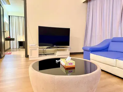 a living room with a couch and a tv at Texas Service Suites At BTS Kuala Lumpur in Kuala Lumpur