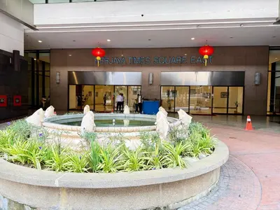 a lobby with a fountain in the middle of a building at Residential Family Apartments At Times Square KL in Kuala Lumpur