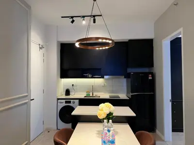 a kitchen with a table with flowers on it at Axon Residence KLCC By Premium Suite in Kuala Lumpur