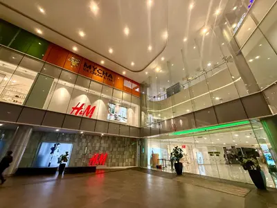 a large building with a shopping mall with lights at Kualalumpur Quill Residences Suites By KLCC in Kuala Lumpur