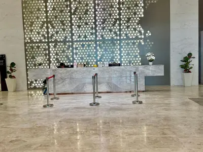 a lobby with a counter with a wall of lights at Kualalumpur Quill Residences Suites By KLCC in Kuala Lumpur