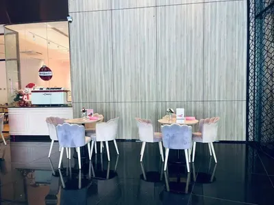 a dining room with a table and white chairs at Aurora Suites At Star Residences in Kuala Lumpur