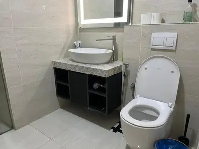a bathroom with a white toilet and a sink at Aurora Suites At Star Residences in Kuala Lumpur