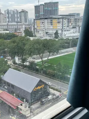 a view of a city with a building and a road at Nour Homestay KLCC View - COMFORT in Kuala Lumpur