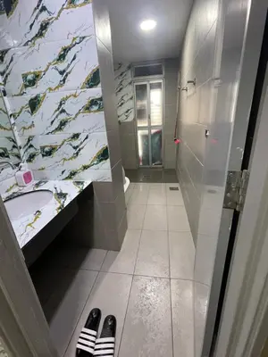 a bathroom with a shower and a sink and a toilet at Nour Homestay KLCC View - COMFORT in Kuala Lumpur